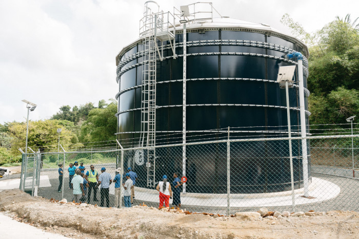 Study tour participants next to 360,000 gallons water storage tank at Tufton Hall, St. Mark, Grenada